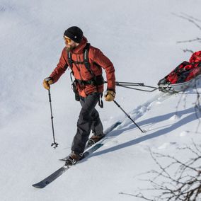 Skier dragging gear in a sled