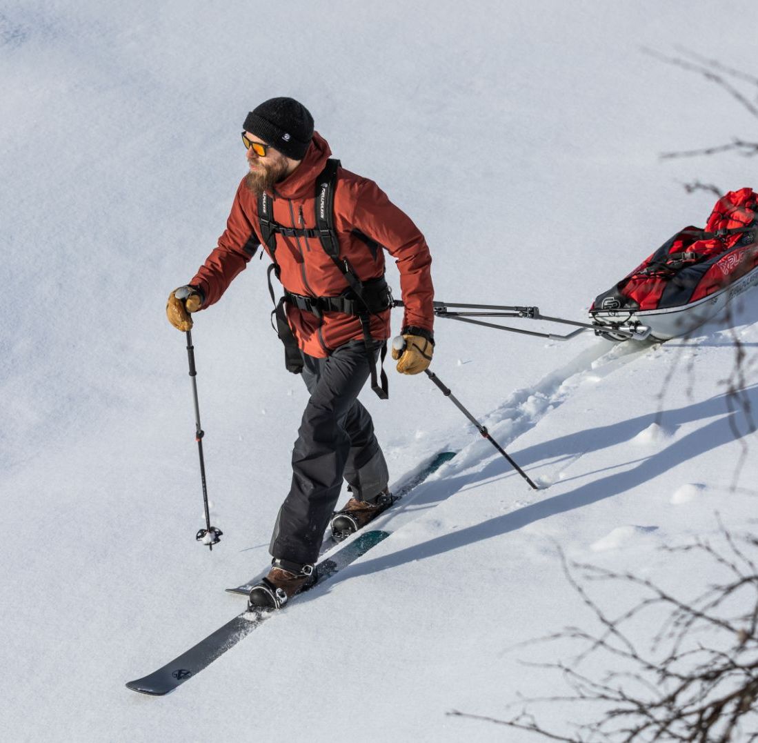 Skier dragging gear in a sled