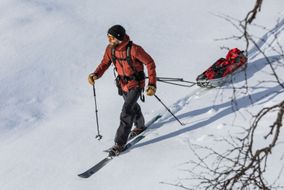 Skier dragging gear in a sled
